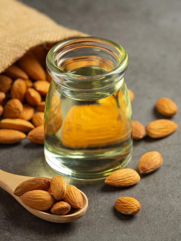 Almond oil in bottle on dark background
