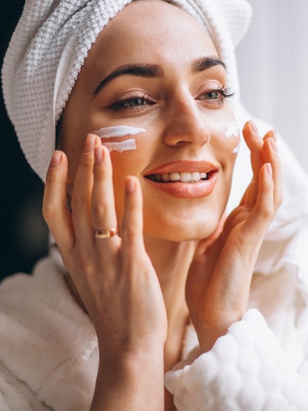 Woman applying face cream