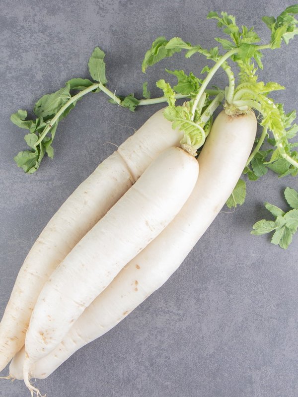A stack of white radishes on the marble background