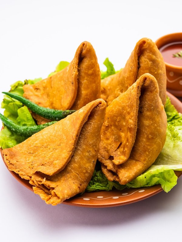 samosa or singara. Indian fried or baked pastry with a savory filling, spiced potatoes, onion, peas