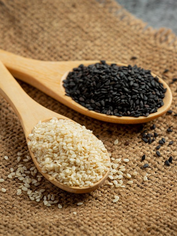 White sesame and black sesame on dark background