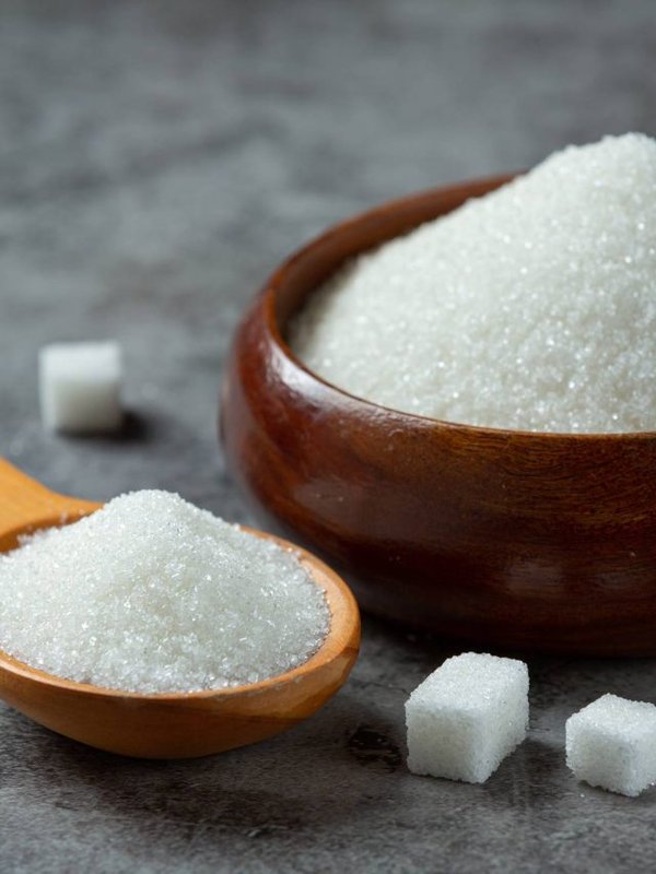 World diabetes day; sugar in wooden bowl on dark background