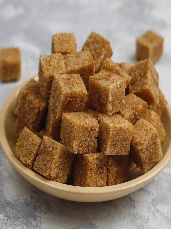 Brown sugar cubes on concrete background,top view