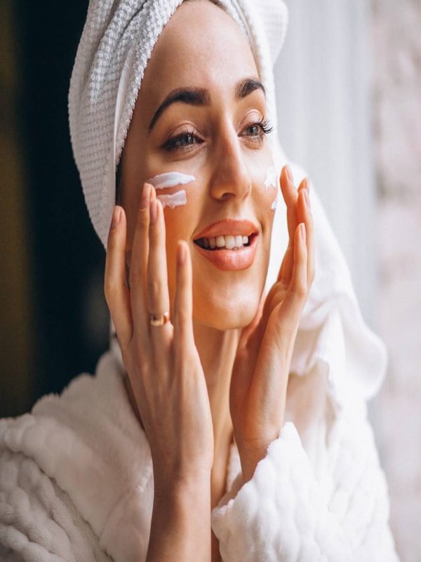 Woman applying face cream
