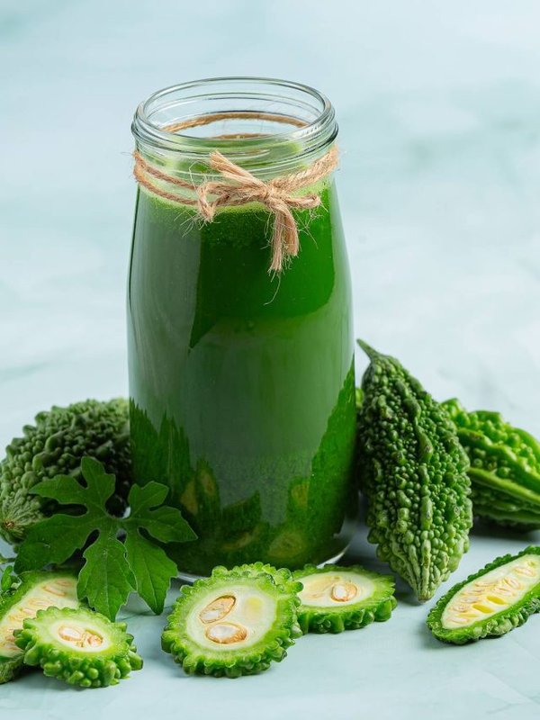 a glass of bitter gourd smoothie with shopped bitter gourd
