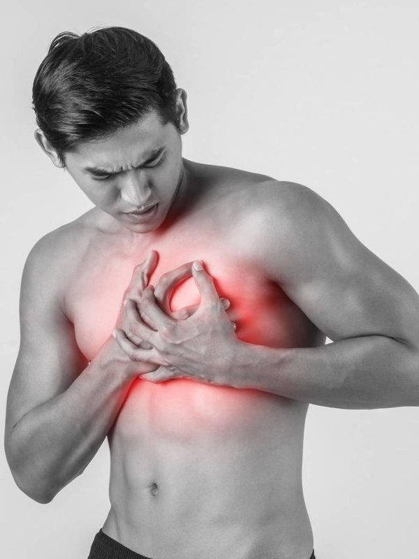 Young man has heart attack isolated on white background.