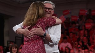 British opposition Labour Party leader Keir Starmer hugs his wife, Victoria on stage in London
