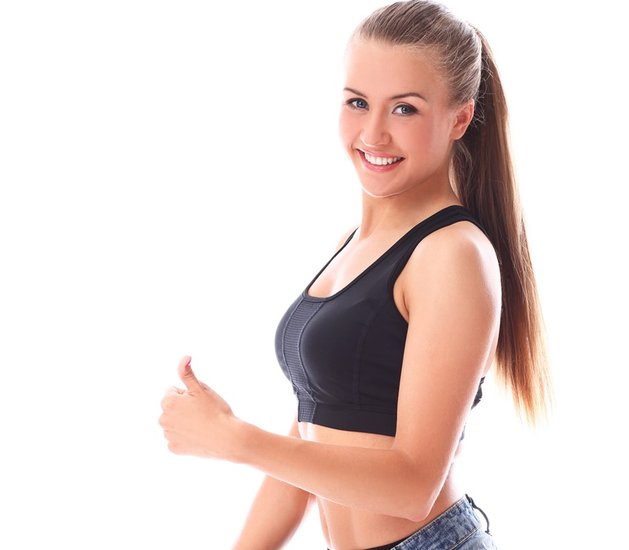 Woman wearing old jeans after weight loss over white background