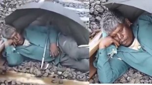 man sleeping on railway tracks, man on railway tracks,