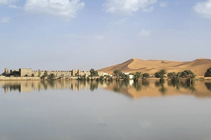 An-oasis-is-reflected-in-a-lake-caused-by-heavy-rainfall-in-the-desert-town-of-Merzouga-near-Rachidia-southeastern-Morocco-Wednesday-Oct.-2-2024