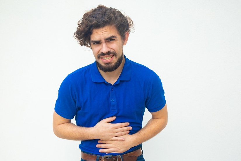 Frustrated unhappy guy suffering from belly ache