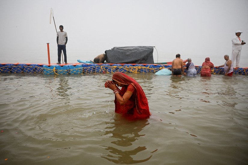 A devotee takes a holy dip at Sangam