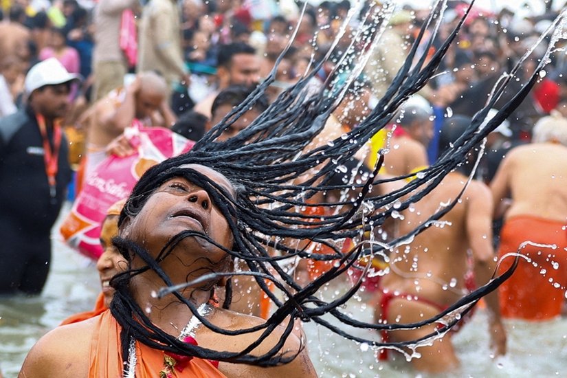 A Sadhvi or Hindu holy woman takes a holy dip