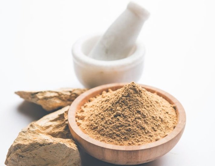 Fuller'S Earth Clay OR Multani mitti in a bowl along with raw stones and mortar