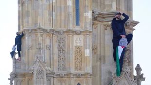 Man climbs Big Ben ,Big Ben Man with Palestinian flag ,