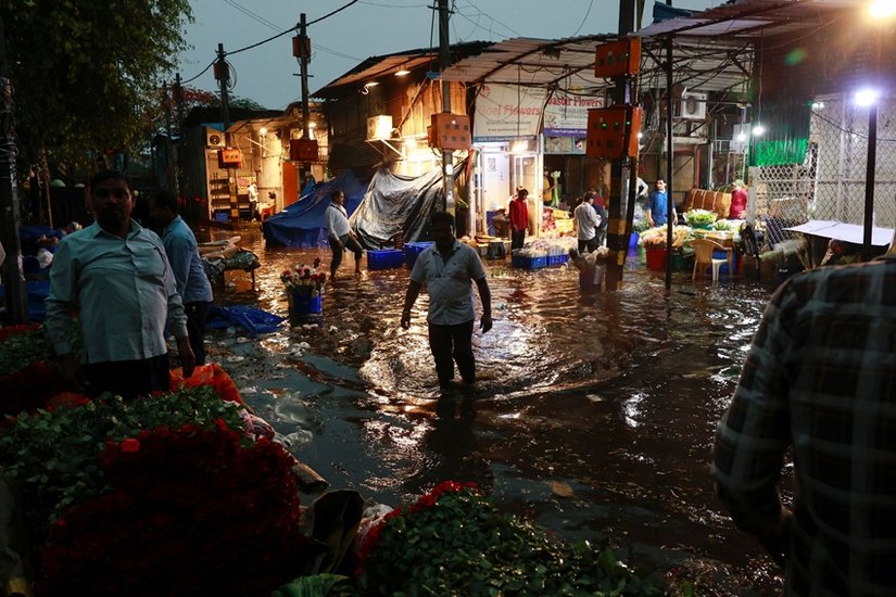 wades through a waterlogged street in a