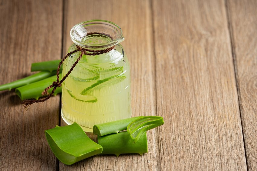 a glass of aloe vera juice put on wooden floor