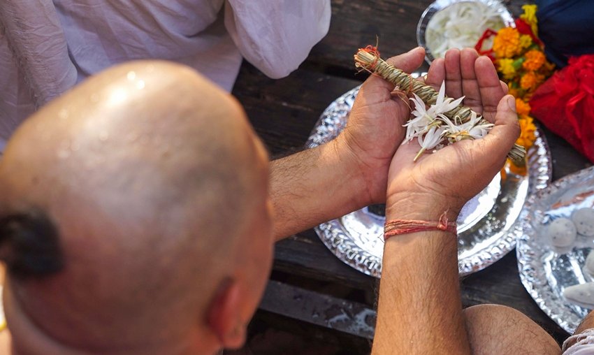 A man performs rituals to pay homage to his ancestors