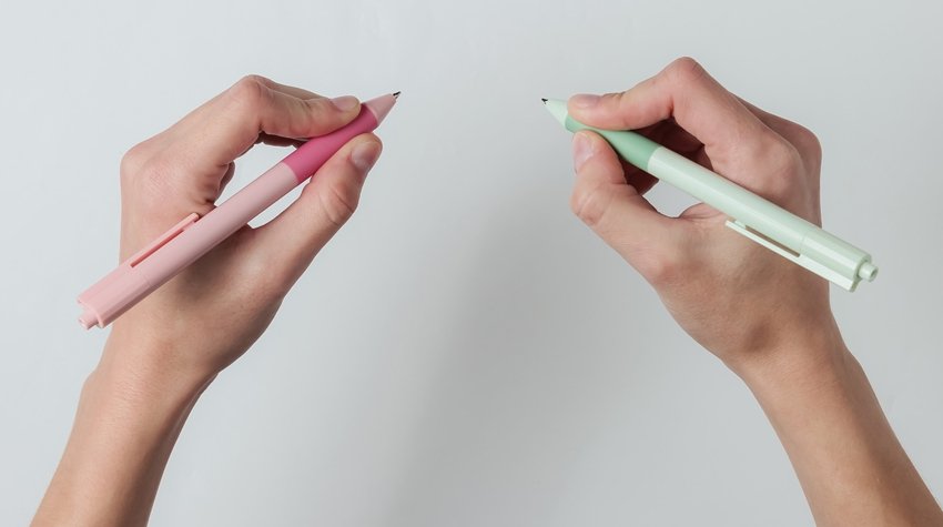 Ambidextr.,Female,Hands,Hold,Pens,And,Write,On,White,Background.
