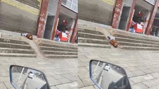 Child sliding on slope while lying on his back in viral video