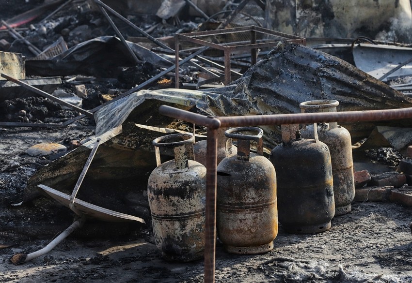 remains at the fire site slum area near the Tedhi Puliya locality under Vikas Nagar police station following a fire incident