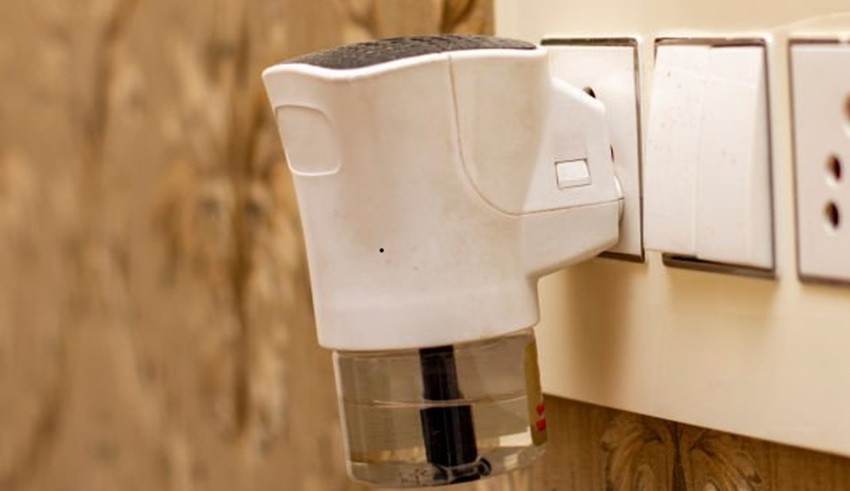 White mosquito killer. Electric mosquito raptor at outlet on the wall.