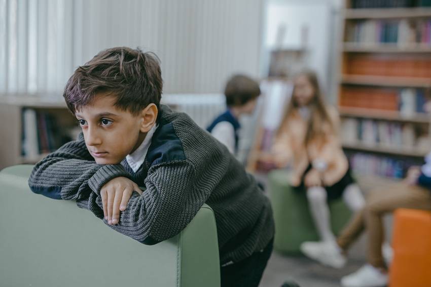 child distancing themselves from friends and staying alone